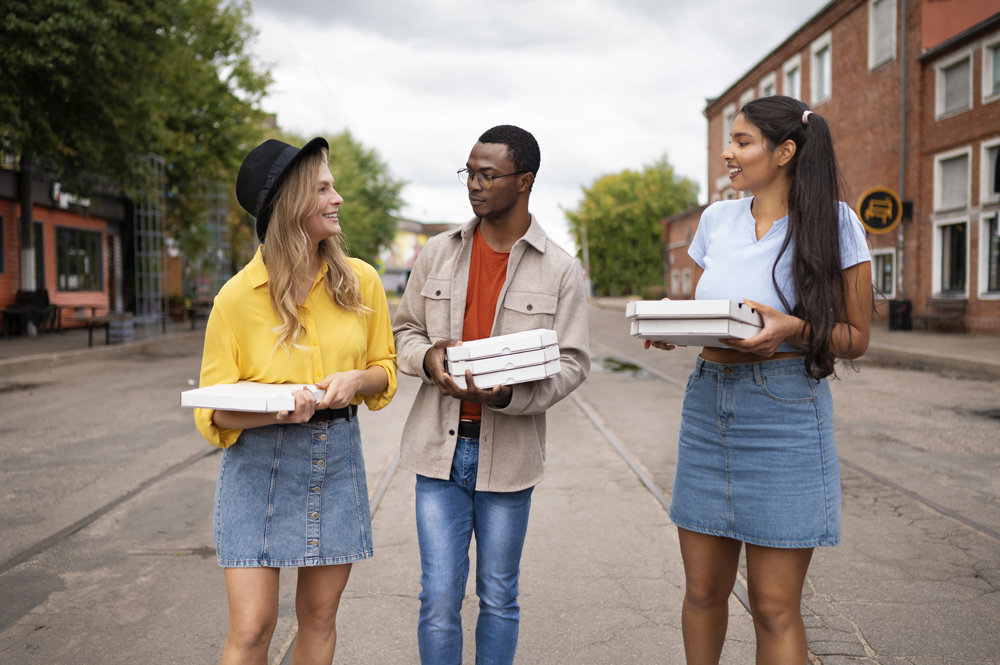 friends with pizza outside front view